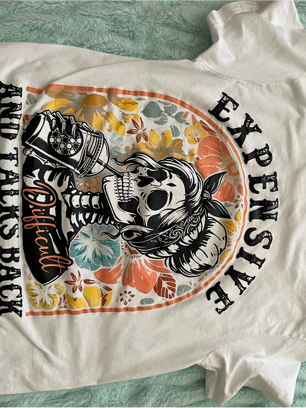 Women’s White Long Sleeve Graphic Tee with Floral Skull Print